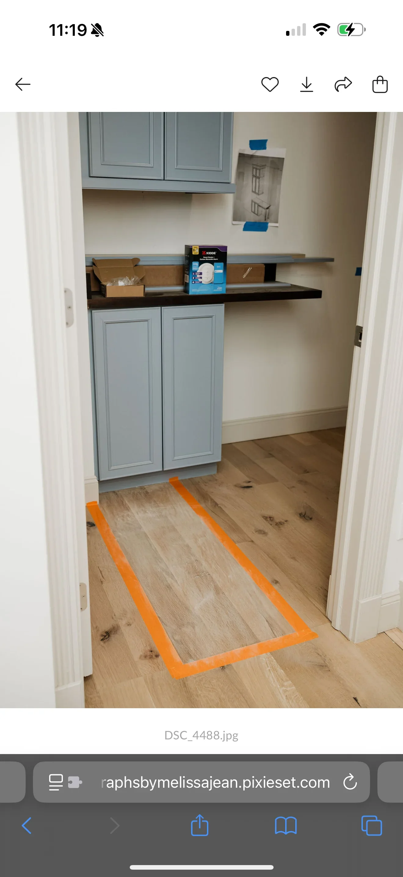 Light blue painted kitchen cabinets with black countertop and floating shelves in progress